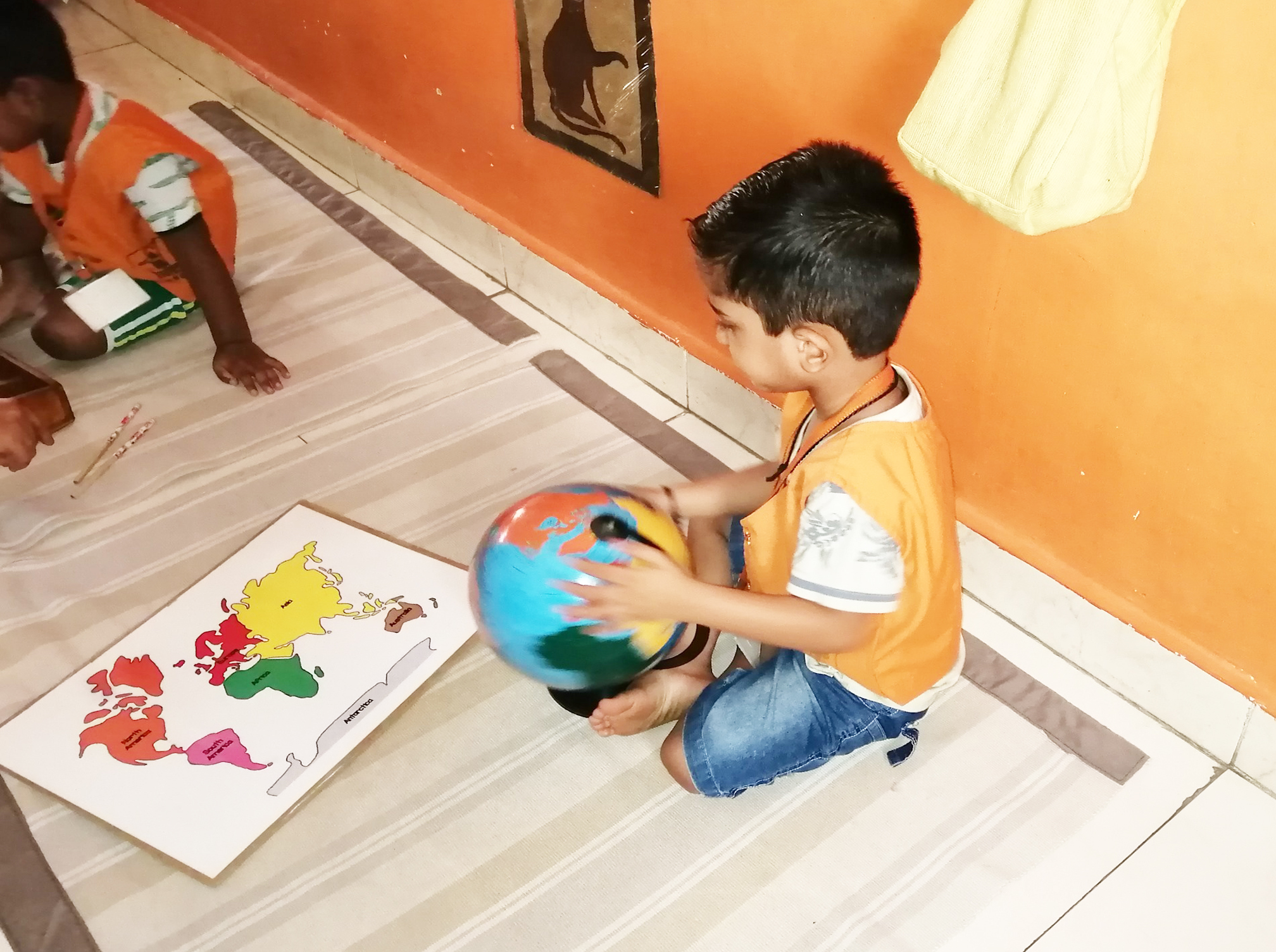  A Child in A B CUBE working with Globe